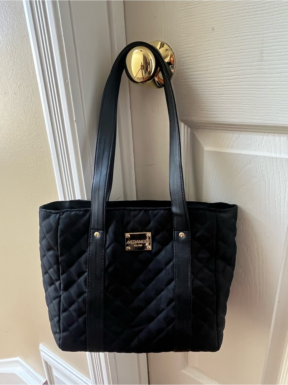 Black quilted insulated tote for carrying hot or cold items on the go